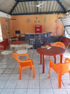 a restaurant with tables and chairs and a counter at Chalet El Paraiso in Escuintla