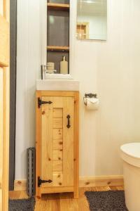 a bathroom with a sink and a toilet at Homestead Hut 