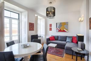 a living room with a couch and a table at BmyGuest - Príncipe Real Galeria Apartment in Lisbon