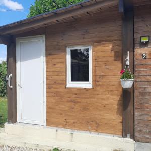 a building with a door and a window and a flower pot at Holiday Chalet 2 Set in Country side in Bouteilles-Saint-Sébastien
