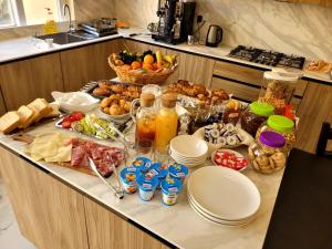 a buffet of food on a counter in a kitchen at Azure W B&B in San Lawrenz