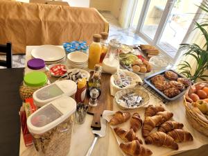 a table with bread and other foods on it at Azure W B&B in San Lawrenz