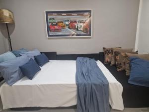 a bedroom with a bed with a painting on the wall at Casa Rita-Superior Room in Giarre