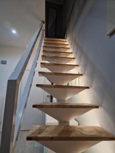 a staircase in a house with wooden shelves at Casa Rita-Superior Room in Giarre