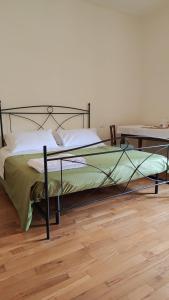a bed with a metal frame in a bedroom at L'attico del 1600 in centro in Perugia
