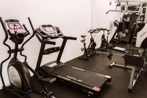 a gym with three bikes and a treadmill at Hotel la Ciudad in Barrancabermeja