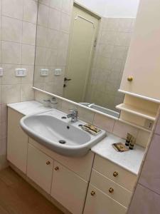 a bathroom with a sink and a mirror at L'attico del 1600 in centro in Perugia
