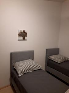 two beds in a room with a cross on the wall at Modern Villa with Garden & Terrace, 13 min to Pula Arena in Pula