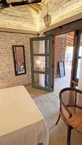 a room with a table and a mirror and a chair at Nongu Home in Trincomalee