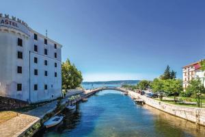 a bridge over a river with boats in the water at Schwarz pool house in Crikvenica