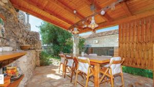 a wooden patio with a wooden table and chairs at Schwarz pool house in Crikvenica