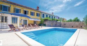 a swimming pool in front of a house at Schwarz pool house in Crikvenica