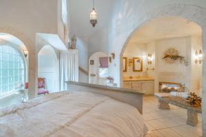 a bedroom with a large bed and a bath tub at The Cottage and Castle in Chemainus +6 photos