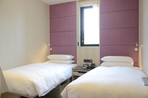 Voodi või voodid majutusasutuse Royal Jade Boutique Hotel toas