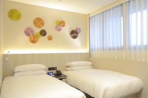 Voodi või voodid majutusasutuse Royal Jade Boutique Hotel toas