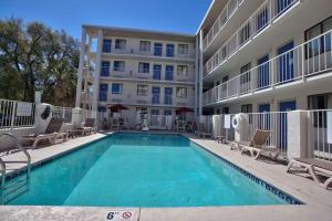 a swimming pool in front of a apartment building at Loyalty Inn Tallahassee in Tallahassee