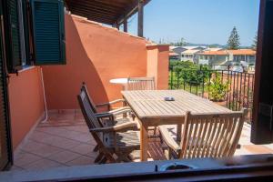 Fotios Roof apartment في أكارافي: طاولة وكراسي خشبية على الفناء