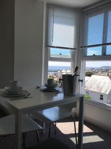 Una mesa en una habitación con ventana y vistas en Modern Studio Apartment with harbour views, en Penzance