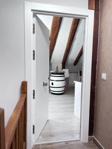 an open door to a room with a barrel at Apartamentos Numancia in Garray