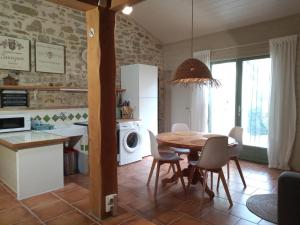 a kitchen and dining room with a table and chairs at Au Repos in Tréziers +30 photos