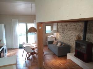 a living room with a couch and a stove at Au Repos in Tréziers