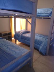 two bunk beds in a room with a window at Antonia in Guaymallen