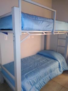 a bunk bed with two blue bunk beds in a room at Antonia in Guaymallen