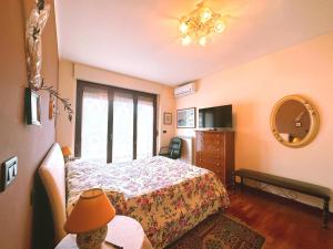 a bedroom with a bed and a table and a mirror at La casa di Marcella in Pescara
