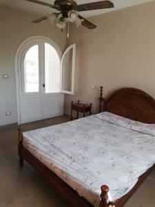 a bedroom with a bed and a ceiling fan at Northern Coast - Private Resort Holiday Home in Alexandria