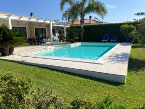 a swimming pool in the yard of a house at Alloggio turistico Villa Camelia Lavinio in Anzio