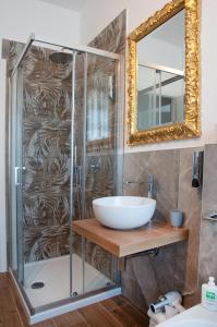 a bathroom with a shower with a sink and a mirror at Arena d'Intorno in Verona