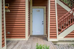 a white door on the side of a house at Tremblant Les Eaux by Rendez-Vous Mont-Tremblant in Mont-Tremblant +75 photos