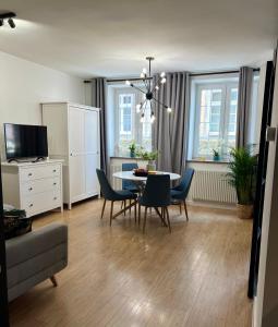 a living room with a dining room table and chairs at Holiday Apartment Old Town Gdansk with a Jacuzzi in Gdańsk