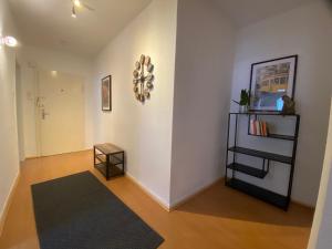 a living room with a black rug and a white wall at Sali - E8 - WLAN, Self Check-In, 8PAX in Essen