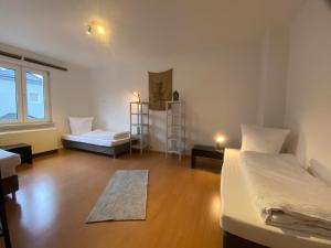 a room with two beds and a wooden floor at Sali - E8 - WLAN, Self Check-In, 8PAX in Essen