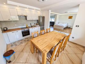 a kitchen and dining room with a wooden table and chairs at Villa Sara in Sarajevo