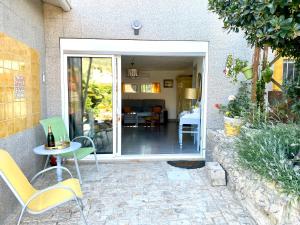 un patio con mesa y sillas frente a una casa en Quinta das flores, en Vale de Pradinhos