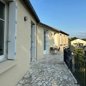 a walkway between two buildings with a patio at La Maison d'Heidi in Saint-Georges-sur-la-Prée