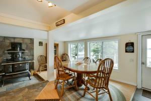 a dining room with a table and chairs and a fireplace at Peaceful Fishermans Paradise with Deck and Fire Pit! in Winthrop