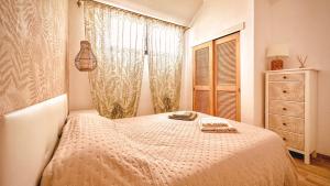 a small bedroom with a bed and a window at Diamond Roof in Los Cristianos