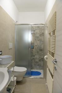a bathroom with a shower with a toilet and a sink at Il Giardino dei Ricordi in Alberobello
