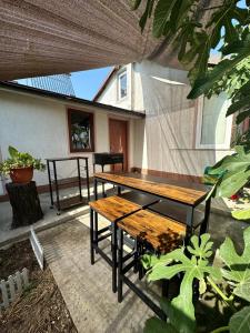 a patio with a wooden table and benches at La Mosie in Corbu