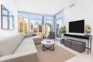 a living room with a couch and a flat screen tv at Level Chicago Fulton Market in Chicago