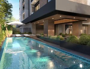 a house with a swimming pool in front of a building at Apartamento de lujo en zona 10 in Guatemala