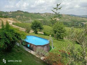 a swimming pool in the middle of a field at Ca D'Enrica in Calosso