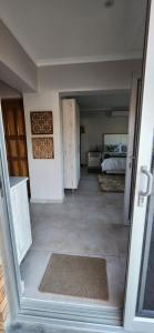 an open door to a room with a bedroom at Audrey's Self-Catering Accommodation in Cape Town