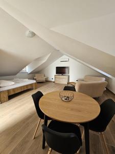 a living room with a table and chairs and a couch at Harmony suites in Bol