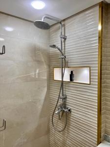 a shower with a shower head in a bathroom at Smart Holiday Cabo Negro in Cabo Negro