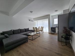 a living room with a couch and a table at Harmony suites in Bol