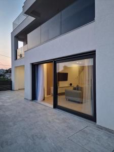 a large glass window of a house with a couch at MA Apartments in Senj